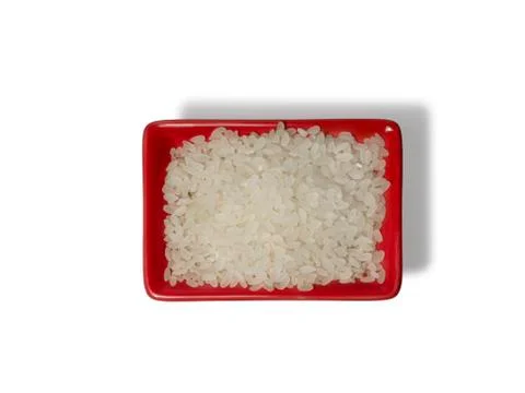 Rice in a red rectangular saucer isolated on white background. The view from Stock Photos