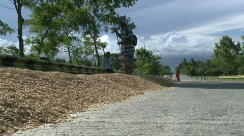 Rice on the road for drying is been turned over Video stock 474881