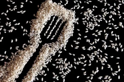 Rice in shape of a fork on black Stock Photos