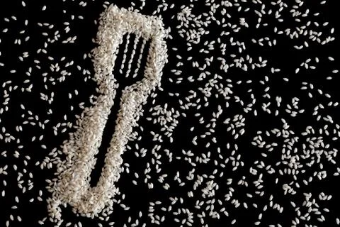 Rice in shape of a fork on black Stock Photos