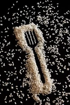 Rice in shape of a fork on black Stock Photos
