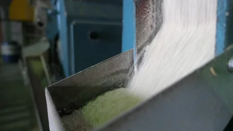 Rice sifting through a large metallic gutter at a contemporary agricultural Stock Footage 144376686