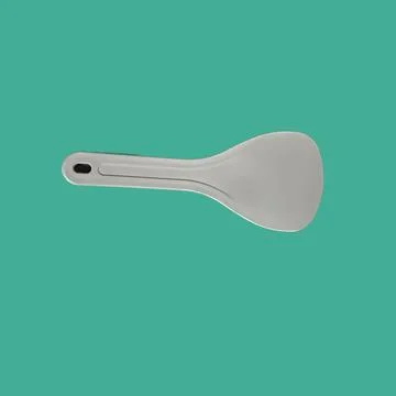 A rice spatula put horizontally in an isolated green background Illustrazione stock
