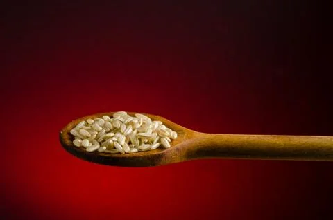 Rice in a spoon, close up, color background.. Foto stock