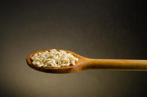 Rice in a spoon, close up, color background.. Stock Photos
