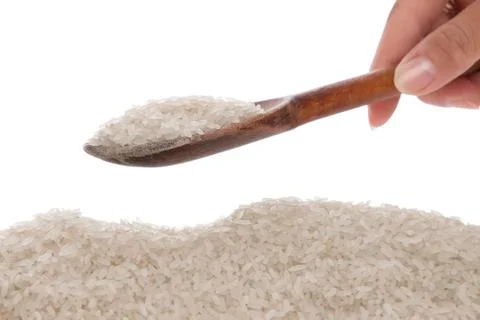 Rice in a spoon on a white background Stock Photos