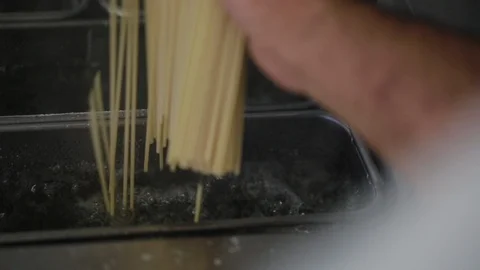 Rice stick noodles being fried in oil at kitchen Stock Footage 108731953