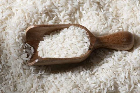 Rice texture on background. Rice in rustic scoop with grains. Rice detail. Stock Photos