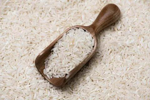 Rice texture on background. Rice in rustic scoop. Rice macro with grains. Ric Stock Photos