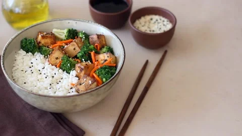 Rice with tofu, broccoli, carrots and sesame. Bowl. Healthy eating. Stock Footage 190884673