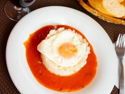 Rice with tomato and fried egg. Cuba style rice closeup Stock Photos