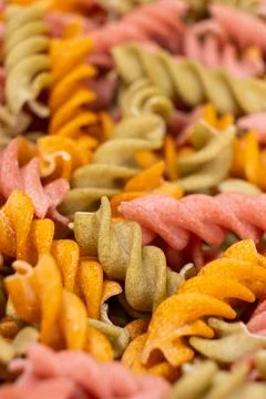 Rice vegetable pasta in the form of spirals, top view. Healthy rice pasta with Stock Photos