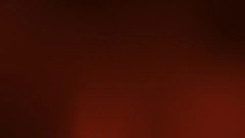 Rich brown gradient with subtle vignetting forms a seamless loop background. 4K Stock Footage 309700905