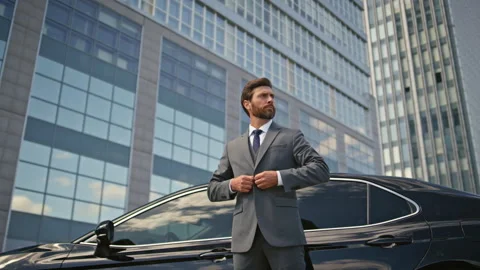Rich businessman posing car buttoning jacket. Elegant man standing urban street Video stock 260358891
