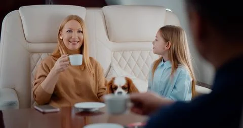 Rich couple flying first class with daughter and dog Stock Photos