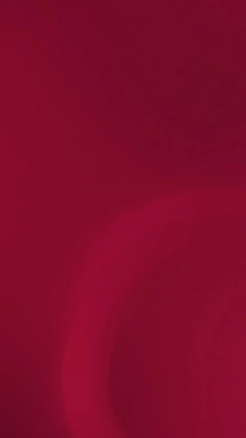 Rich crimson background with subtle, circular gradient. Smooth textures. 库存影片 309701530