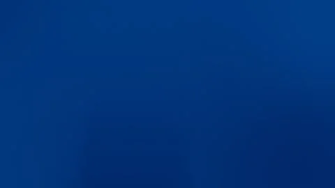 Rich deep blue seamless loop background. Smooth gradient with subtle texture. Vídeo Stock 309058571