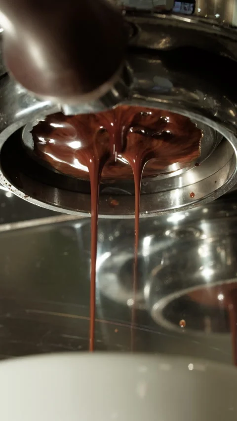 Rich espresso pouring from the group head into cup. Professional espresso Stock Footage 314436958