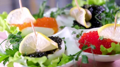 Rich live deviled eggs Luxury Hotel Red and black caviar on a plate spins on a Stock Footage 277036735