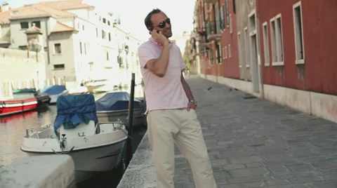 Rich man with cellphone standing in Venice Stock Footage