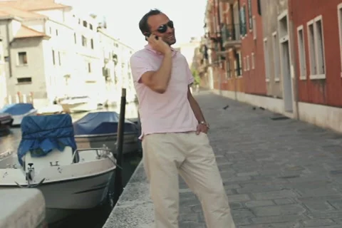 Rich man with cellphone standing in Venice Stock Footage