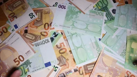 Rich man puts his hands in the money on the table Stock Footage 120514636