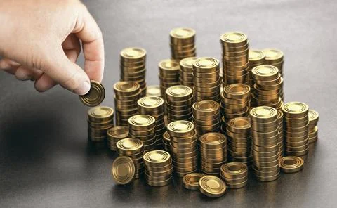 Rich man stacking golden money coins. Income saving plan. Stock Photos