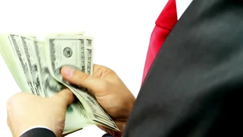 Rich man in suit on white background holding bundle of dollar money in his Stock-Footage 336263983