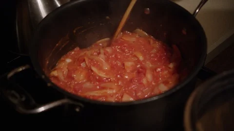 Rich red pasta sauce and onions being cooked and stewed in pot Stock Footage 123737185