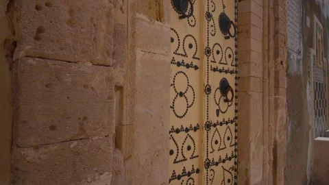 Richly decorated door frame with yellow door in Sousse. Stock Footage 296385149