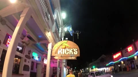 Ricks tree top bar street sign on duval street at night in key west florida k Stock Footage 41869862