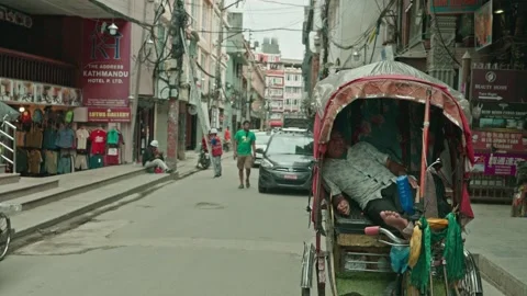 Rickshaw Driver Sleeping on Street in Thamel Kathmandu Nepal on a Cloudy Day Stock Footage 316479885