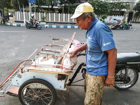 A rickshaw puller is waiting for passengers Stock Photos