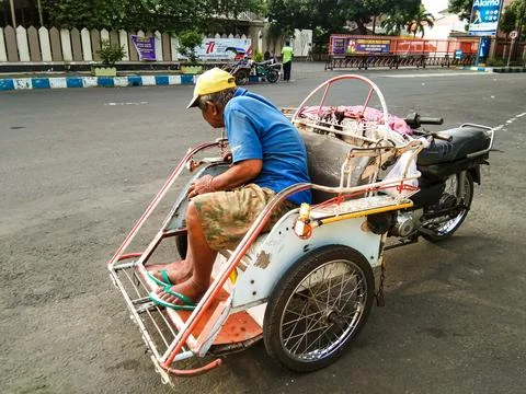 A rickshaw puller is waiting for passengers Stock Photos
