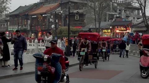 Rickshaws driving through Houhai Lake in Beijing Stock Footage 134847985