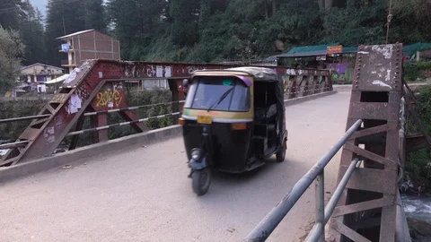 Rickshaws riding across the bridge to Old Manali, Himachal Pradesh, India Stock Footage 96113221