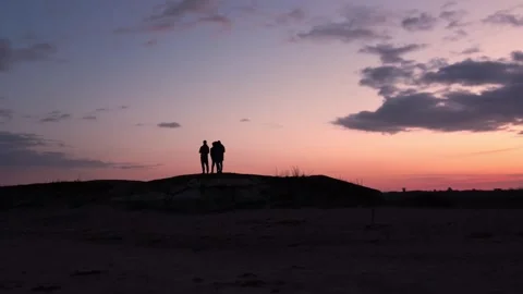 Ride along the beach with the clouds and the sunset in the background. Stock Footage 258868077