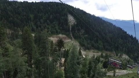 Ride on a cable car. View from the ski lift in the mountains to the green gorge Stock Footage 165462860