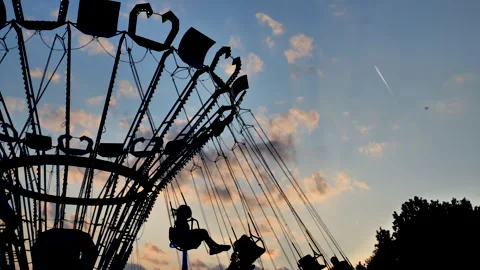 Ride on chain swing carousel in amusement park on sunset Video stock 244089636