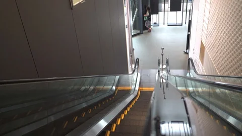 Ride down an escalator with Camera on Hand Rail Stock Footage