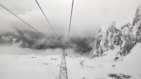Ride down the mountain in the cable car. Clouds below the mountains Stock Footage 230178285