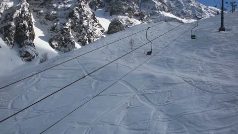 Ride on an empty cableway in  snowy mountains Stock Footage 114976830