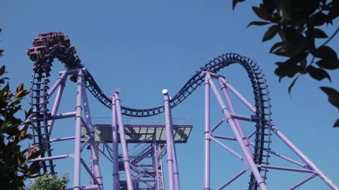 Ride on a heart shaped roller coaster on bright blue sky background Stock Footage 155395242