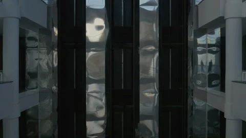 A ride in a modern glass elevator as the camera pans smoothly capturing Stock Footage 327391985