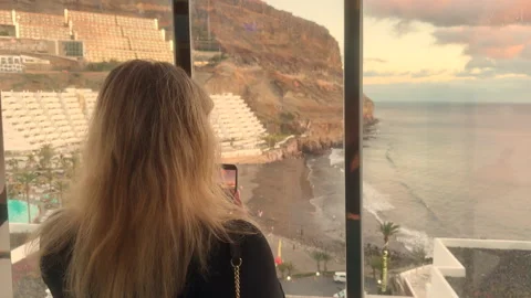 A ride in a modern glass elevator as the camera pans smoothly capturing Stock Footage 327545963