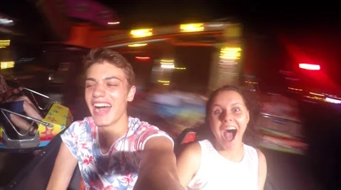 Ride in motion in theme park during the evening, young couple fun Video stock 56030476
