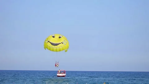 To ride a parachute it is high over the sea. Entertainment on a resort beach Stock Footage 140598331
