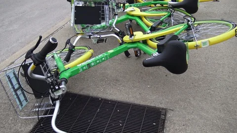 Ride share bikes on the side of the road downtown Stock Footage 88286543