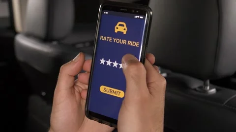 Ride Sharing User Giving an 5 Stars Rating on a Smartphone app to the Driver Stock Footage 135099259