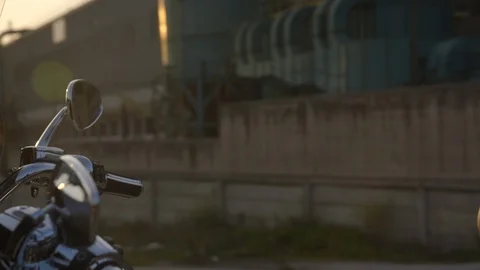 Rider getting ready to drive Harley-Davidson motorbike in slow motion Stock Footage 89979365